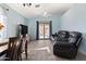 Bright living room with tile floors, fan, and sliding glass doors to the pool area at 16934 N 158Th Ave, Surprise, AZ 85374