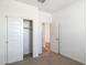 Bedroom with sliding closet doors and access to bathroom at 17747 W Mission Ln, Waddell, AZ 85355