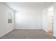 Bedroom with carpet, window, and en-suite bathroom access at 17747 W Mission Ln, Waddell, AZ 85355