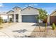 Modern curb appeal with gray garage door and small front yard at 17747 W Mission Ln, Waddell, AZ 85355