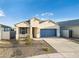 New single-story home with light-colored exterior and blue garage door at 17747 W Mission Ln, Waddell, AZ 85355