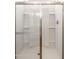 Clean and bright shower with glass doors and storage shelves at 17747 W Mission Ln, Waddell, AZ 85355