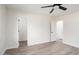 Well-lit bedroom with ceiling fan and access to closets at 17831 N 130Th Ave, Sun City West, AZ 85375