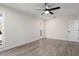 Light and airy bedroom featuring wood-look floors and a ceiling fan at 17831 N 130Th Ave, Sun City West, AZ 85375