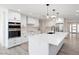 Elegant kitchen with white cabinetry, quartz countertops, and modern pendant lighting at 17831 N 130Th Ave, Sun City West, AZ 85375