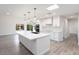 Modern kitchen featuring white cabinets, a large island with a sink, and stainless steel appliances at 17831 N 130Th Ave, Sun City West, AZ 85375