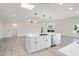 Modern kitchen island with white cabinets and black appliances at 17831 N 130Th Ave, Sun City West, AZ 85375