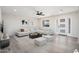 Bright living room with light gray sectional sofa, coffee table, and wood-look floors at 17831 N 130Th Ave, Sun City West, AZ 85375