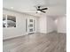 Open living room with wood-look floors, neutral walls, and a modern front door at 17831 N 130Th Ave, Sun City West, AZ 85375