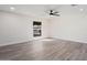 Bright living room featuring hardwood floors and a ceiling fan at 17831 N 130Th Ave, Sun City West, AZ 85375