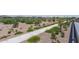 Paved pathway meanders through a desert landscape with young trees and plants at 18242 W Colter St, Litchfield Park, AZ 85340