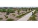 A paved pathway winds through a neighborhood park with desert landscaping at 18242 W Colter St, Litchfield Park, AZ 85340