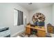 Home office with wood desk, computer, and wall decor at 18242 W Colter St, Litchfield Park, AZ 85340