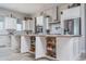 White kitchen with large island, open shelving, and game storage at 18242 W Colter St, Litchfield Park, AZ 85340