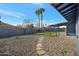 Backyard with gravel, grass, and stone pathway at 1845 E Hampton Ave, Mesa, AZ 85204