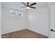 Simple bedroom with a ceiling fan and large window, offering natural light at 1845 E Hampton Ave, Mesa, AZ 85204