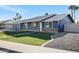 Newly renovated home with a blue exterior, brick accents, and a landscaped yard at 1845 E Hampton Ave, Mesa, AZ 85204