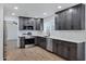 Modern kitchen with dark cabinets, white countertops, and stainless steel appliances at 1845 E Hampton Ave, Mesa, AZ 85204