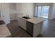 Modern kitchen with island, stainless steel appliances, and white cabinets at 18864 E Bruno Dr, Gold Canyon, AZ 85118