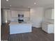 Open kitchen with white cabinets and large island at 18864 E Bruno Dr, Gold Canyon, AZ 85118