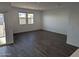 Spacious living room with large windows and wood-look tile floors at 18864 E Bruno Dr, Gold Canyon, AZ 85118