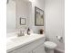 Stylish half bathroom with white vanity and framed print at 19042 W Clinton St, Surprise, AZ 85388