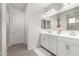 Elegant bathroom with double vanity, white cabinets, and a large mirror at 19042 W Clinton St, Surprise, AZ 85388