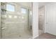 Modern bathroom with a glass shower enclosure and neutral tile at 19042 W Clinton St, Surprise, AZ 85388