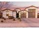 Beautiful two-story home with a three-car garage and desert landscaping at 19042 W Clinton St, Surprise, AZ 85388