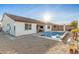 Single-story home with a covered patio and sparkling pool at 19042 W Clinton St, Surprise, AZ 85388