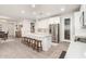 Bright kitchen with white cabinets, an island with seating, and stainless steel appliances at 19042 W Clinton St, Surprise, AZ 85388