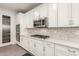 Modern kitchen with white cabinets, stainless steel appliances, and hexagon backsplash at 19042 W Clinton St, Surprise, AZ 85388