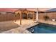 Charming pergola-covered patio overlooking a sparkling pool at 19042 W Clinton St, Surprise, AZ 85388