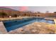 Stunning pool with stone coping and a water feature at 19042 W Clinton St, Surprise, AZ 85388