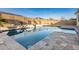 Inviting swimming pool with stone deck and water feature at 19042 W Clinton St, Surprise, AZ 85388