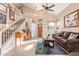 Living room with high ceilings, staircase, and leather sofas at 19410 N 77Th Dr, Glendale, AZ 85308