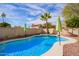 Inviting kidney-shaped pool with waterfall feature and ample patio space at 19410 N 77Th Dr, Glendale, AZ 85308