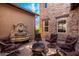 Spacious backyard features a beautiful stone water feature, firepit, and outdoor seating area at 20620 W Walton Dr, Buckeye, AZ 85396