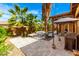 Tropical backyard oasis includes a pool, desert landscaping, gazebo, and outdoor dining at 20620 W Walton Dr, Buckeye, AZ 85396