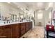 Bathroom with a dual sink vanity, tile floor, and a large mirror at 20620 W Walton Dr, Buckeye, AZ 85396