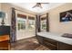 Bedroom with a ceiling fan, wooden floors, and three windows at 20620 W Walton Dr, Buckeye, AZ 85396