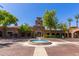 Stunning clubhouse featuring a water fountain, manicured landscaping, and beautiful architecture at 20620 W Walton Dr, Buckeye, AZ 85396