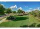 Inviting neighborhood green space featuring sidewalks, green grass and desert landscaping at 20620 W Walton Dr, Buckeye, AZ 85396