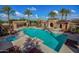 Relaxing community pool with jacuzzi, shaded seating, and desert landscaping under blue skies at 20620 W Walton Dr, Buckeye, AZ 85396