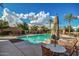 Community pool featuring palm trees, lounge chairs, and a comfortable seating area with shade umbrella at 20620 W Walton Dr, Buckeye, AZ 85396