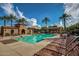 Lounge seating surrounds the well-maintained community pool and covered grilling area with palm tree landscaping at 20620 W Walton Dr, Buckeye, AZ 85396