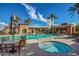 Community pool and jacuzzi with lounge seating, umbrellas, and cabana-style grilling area with seating at 20620 W Walton Dr, Buckeye, AZ 85396