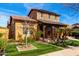 Two story home features a covered porch and manicured lawn at 20620 W Walton Dr, Buckeye, AZ 85396