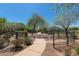 Path through greenway featuring mature trees, vegetation, benches, and community access at 20620 W Walton Dr, Buckeye, AZ 85396