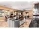 Open kitchen with a copper sink, granite countertops, and seamless access to the living room at 20620 W Walton Dr, Buckeye, AZ 85396